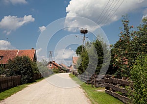 Idyllic street in an old town featuring vibrant red houses surrounded by lush greenery