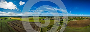 Idyllic summer landscape with clear mountain fields and the Alps at the horizon.