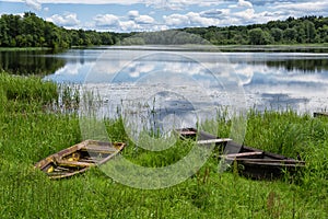 Idyllic summer landscape with fishing boats by the lake