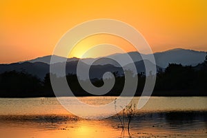 Dramatic sunset over the lake mountains and the sea with Fog of Kaeng Krachan Dam,Phetchaburi Province Thailand.