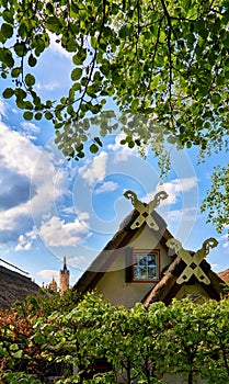 Idyllic thatched roof with decorations and a small window