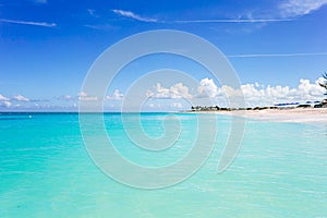 Idyllic tropical beach in Caribbean with white sand, turquoise ocean water and blue sky