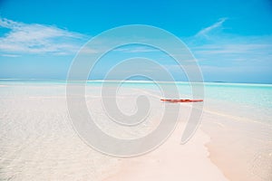 Idyllic tropical beach in Caribbean with white sand, turquoise ocean water and blue sky