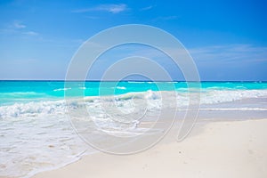 Idyllic tropical beach on Cuba in Caribbean with white sand, turquoise ocean water and blue sky photo