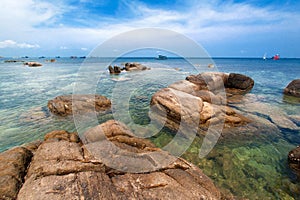 Idyllic tropical beach with rock and crystal clear water