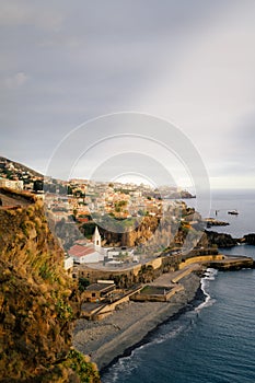 Idyllic tropical beach scene featuring a sandy shoreline, a dramatic cliff face