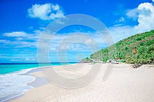 Idyllic tropical beach with white sand, turquoise ocean water and blue sky