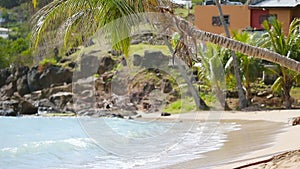 Idyllic tropical Carlisle bay beach with white sand, turquoise ocean and blue sky at Antigua island in Caribbean