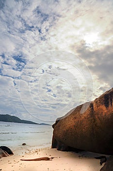 Idyllic tropical remote beach with granitie rock and blue sky