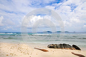 Idyllic tropical remote beach with granitie rock and blue sky