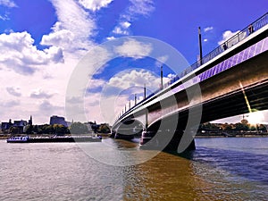 Idyllic view of Bridge over Rhine river against sunset in the city of Bonn, Germnay. Backlighting of bridge against dawn