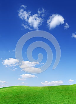 Idyllic view, green hills and blue sky with white clouds