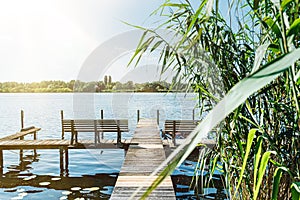 Idyllic view of Havel river in Berlin with pier and reeds on riverbank