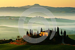 Idyllic view of hilly farmland in Tuscany in beautiful morning light, Italy. Foggy landscape in Tuscany. Belvedere in the