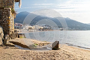 Idyllic view of long sandy beach with mountains in the background, seen from the old harbour on a sunny day in Cefalu, Sicily,