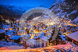 Idyllic village of Zermatt rooftops evening view, luxury winter destination