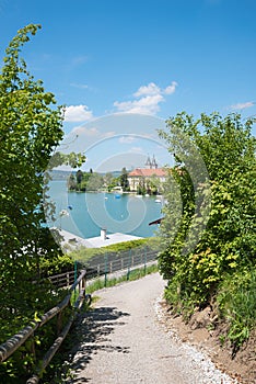 Idyllic walkway with stunning view to lake tegernsee and castle, upper bavaria