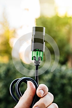 IEC power cord in against green background