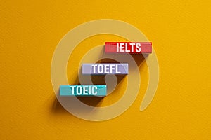 IELTS, TOEFL, TOEIC - word concept on cubes,text