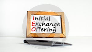 IEO initial exchange offering symbol. Concept words IEO initial exchange offering on beautiful wooden frame. Beautiful white