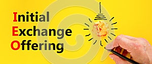 IEO initial exchange offering symbol. Concept words IEO initial exchange offering on beautiful yellow paper. Beautiful yellow