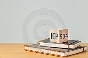 IEP Individual Education Plan Symbol. Business concept, IEP 504 program, copy space, text on a natural wooden block placed on