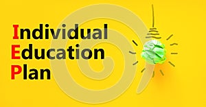 IEP individual education plan symbol. Concept words IEP individual education plan on paper on a beautiful yellow background. Light