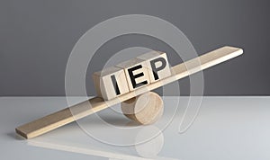 IEP on wooden cubes on a wooden balance , business concept