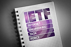 IETF - Internet Engineering Task Force acronym on notepad, concept background