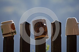 Iew of cups hanging on a fence