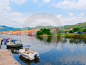 Iew of fishing boats and beautiful colorful houses in the city of Bosa. province of Oristano, Sardinia, Italy