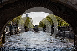iew under a bridge from a boat on Amsterdam canal