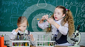 If at first you dont succeed try another experiment. Small school children holding test tubes for laboratory experiment