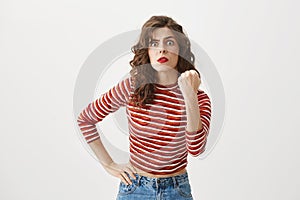 If only I hear this one more time. Attractive angry woman shaking her fist with mad epxression, trying to threated photo