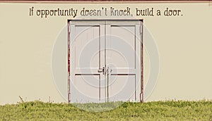 If opportunity doesn`t knock build a door - Motivational Graphic - Double wooden doors build it stucco outdoor wall with grass in