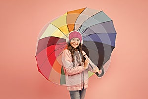 If it should rain. Happy small child in coat hold colorful umbrella against rain. Cute little girl with fashion