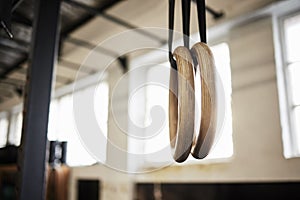 If you want the muscle, youve got to hang on. Still life shot of gymnastic rings in a gym.