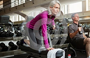 If you want to be fit, dont quit. a senior married couple working out together at the gym.