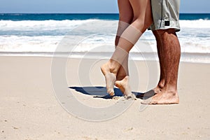 If youre not barefoot youre overdressed. a couple sharing a romantic moment together at the beach.