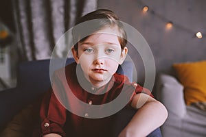 Ifestyle portrait of handsome thoughtful child boy