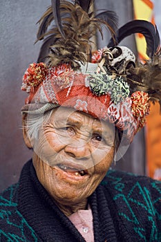 Ifugao woman in national dress next to rice terraces in Banaue, Philippines.