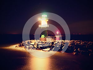 The ighthouse shinning at port gate. Modern light house at the end of stony pier