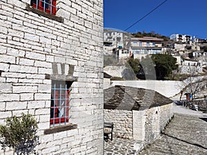 Igiades village on the mountain mitsikeli, greek fllag waving old traditional houses in ioannina