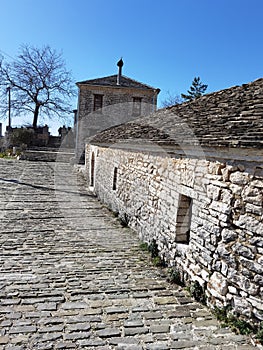 Igiades village on the mountain mitsikeli, greek fllag waving old traditional houses in ioannina