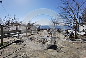 Igiades village on the mountain mitsikeli, greek fllag waving old traditional houses in ioannina