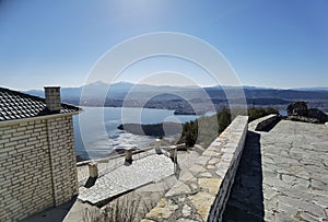 Igiades village on the mountain mitsikeli, greek fllag waving old traditional houses in ioannina