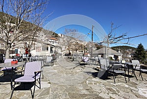 Igiades village on the mountain mitsikeli, greek fllag waving old traditional houses in ioannina