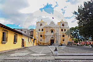 Iglesia De La Merced and cobblestone paved plaza with cross, Antigua, Guatemala photo