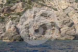 igneous rock hole in cliffs at Uomo cape, Argentario, Italy photo