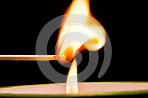 Igniting matches from a candle fire. Sulfur ignition close up. Macro shooting